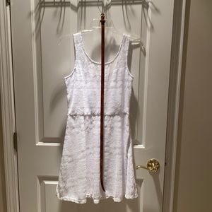 white medium patterned tank dress with thin brown belt